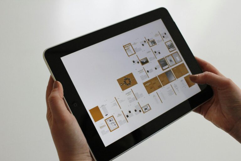 A custom software design files on a ipad held by 2 hands.